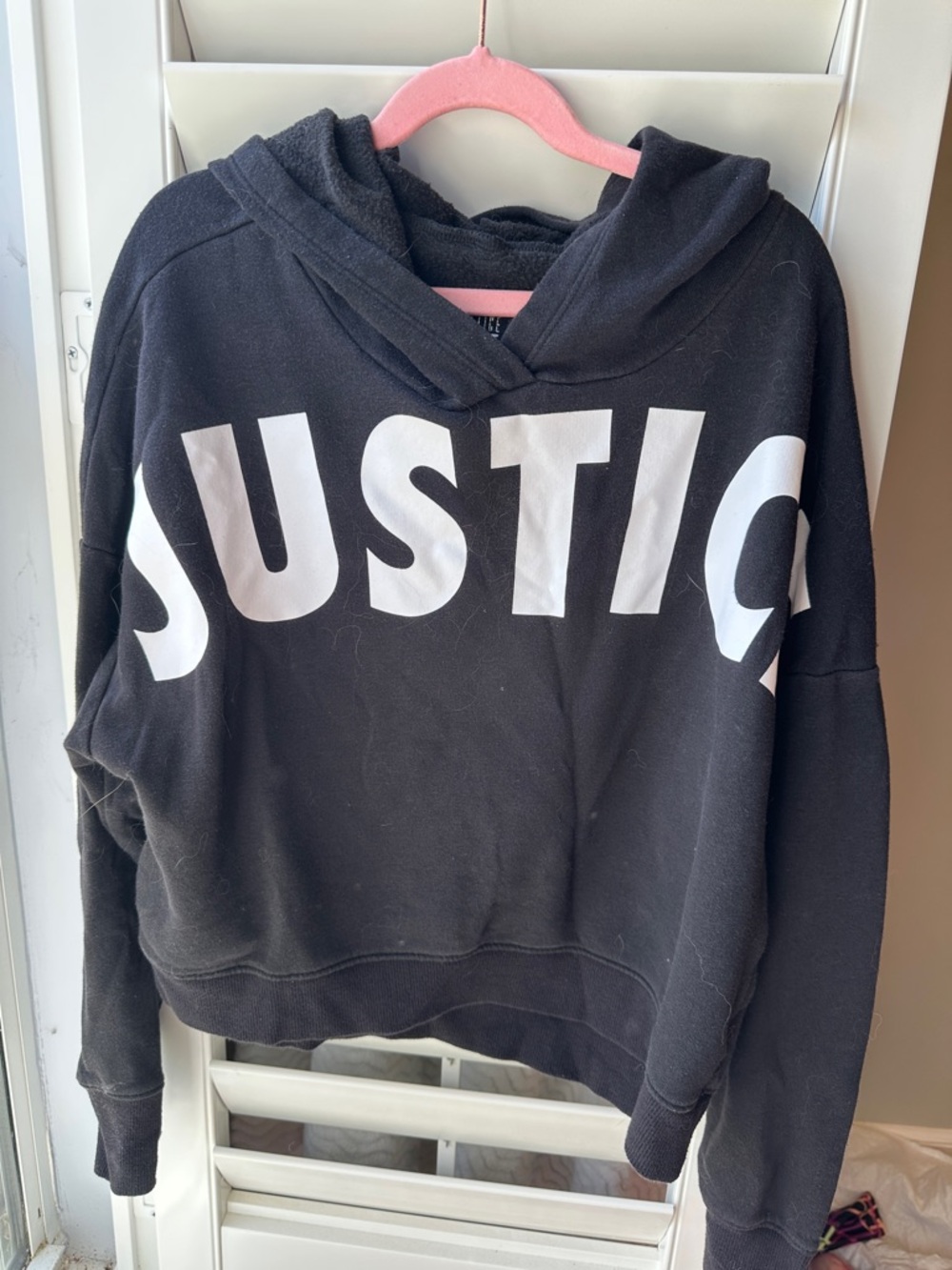 Justice Black Hoodie with White Logo Across Front